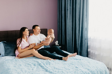 Portrait of a happy young family with a little baby boy.