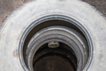 Sewer pit with car tires.