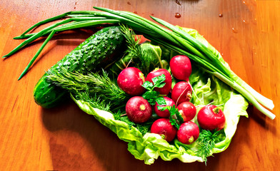 fresh vegetables in basket on wooden background