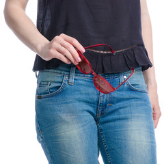 Woman in jeans sunglasses in hand on white background isolation