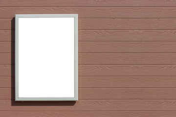 Fototapeta premium empty blank white mock up board on brown wood panels wall background.