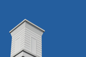 modern retro white wood chimney with blue sky background.