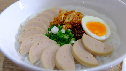 Vietnamese noodle soup in white bowl closeup shot