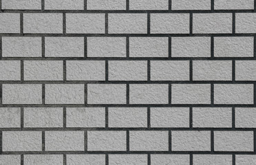 retro weathered old gray brick stack fence wall surface texture background.