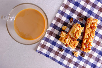 Nut bar and coffee on scottish background