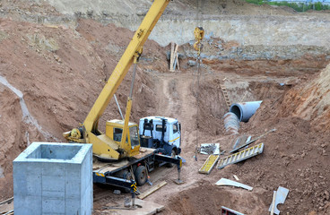 Crane operation in the pit, laying or replacement of underground storm sewer pipes at the...