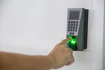Finger scan on machine Security concept and safety. soft focus on hand scanning finger on machine concept. Businessman hand scanning finger on machine,Technology concept or Business concept.