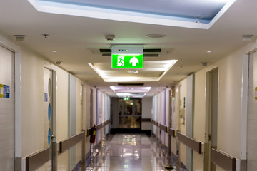 Green emergency exit sign showing the way to escape.Fire exit in the building.