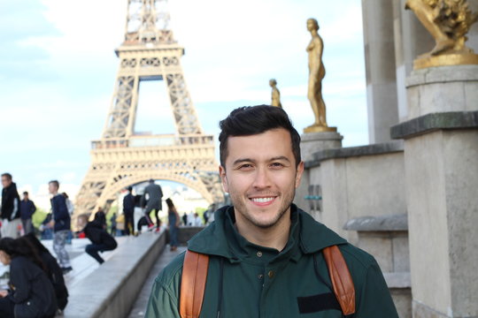 Cute guy taking a touristic picture in France