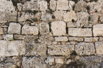 Ancient stone wall surface texture. Close-up detail.