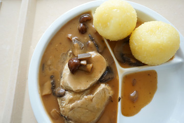 Hunter's roast with Klose and mushrooms in brown sauce served on the tray 