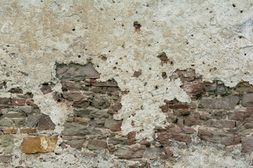 The  high resolution texture of the old brick wall with showered plaster and clay putty. Useful for the texture of the old castle or walls in design, architecture and game development