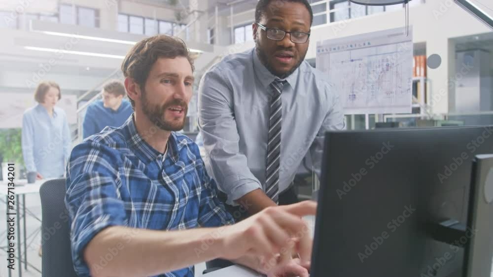 Poster in the industrial engineering facility: portrait of the handsome male engineer working on desktop co