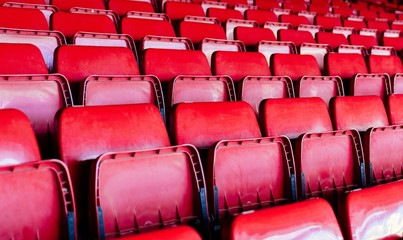 Red plastic empty stadium seats.