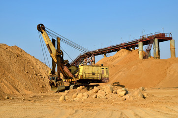 Large excavator in a quarry for the extraction of sand, gravel, rubble, quartz and other minerals