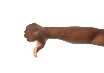 African-American man showing thumb down gesture on white background, closeup