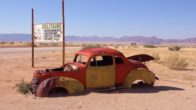 Abandoned and rusting trucks and cars line the road near the tiny oasis settlement of Solitaire, Namibia.