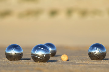 petanque balls on sandy beach