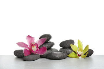 Obraz na płótnie Canvas Beautiful orchid flowers with different spa stones on white background