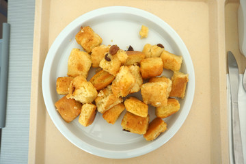 Sugared pancake with stewed plums with apple compote Fruit salad and green salad served on the tray