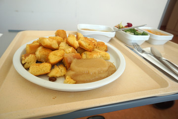 Sugared pancake with stewed plums with apple compote Fruit salad and green salad served on the tray