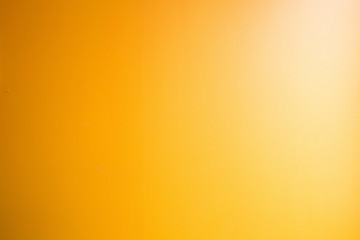 Orange abstract gold background yellow color, light corner spotlight, faint orange vintage background. Colorful
