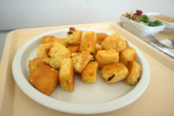 Sugared pancake with stewed plums with apple compote Fruit salad and green salad served on the tray