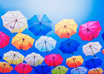 Colorful umbrellas on the sky background.