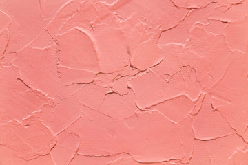 Fototapeta premium Coral red color, textured background, wavy plaster