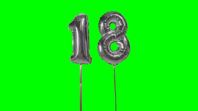 Number 18 eighteen years birthday anniversary silver balloon floating on green screen