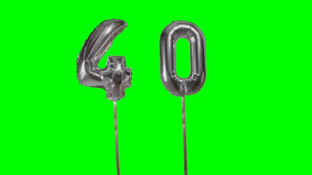 Number 40 forty years birthday anniversary silver balloon floating on green screen