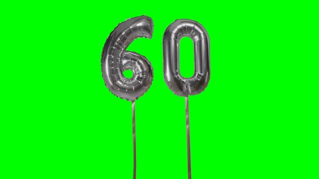 Number 60 sixty years birthday anniversary silver balloon floating on green screen