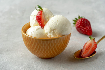 Tasty ice cream with strawberry in bowl on table	