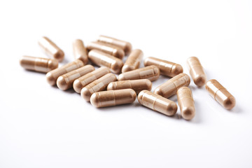 Reishi Mushroom capsules. Concept for a healthy dietary supplementation. White background. Close up. 