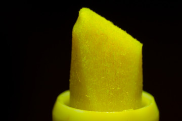 Yellow highlighter macro isolated on black background