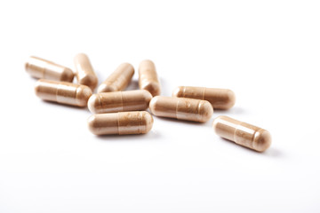 Reishi Mushroom capsules. Concept for a healthy dietary supplementation. White background. Close up. 