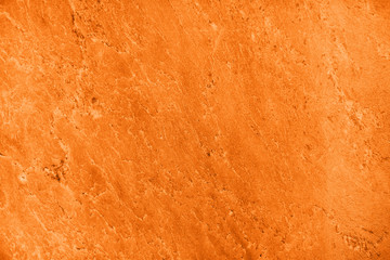 Close up of abstract turmeric orange toned granite stone texture with high resolution. For...