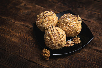 Meringues with butter cream and nuts. on a wooden table background.