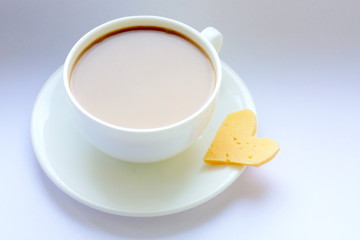  White porcelain cup. Coffee with milk. A cup on the window and a slice of cheese. Love. Morning.