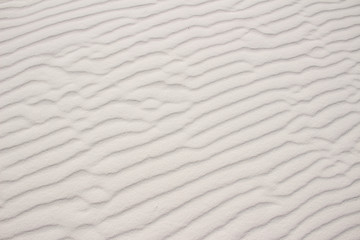 Fototapeta na wymiar Rippled sand background formed by wind taken at White Sands National Monument in New Mexico