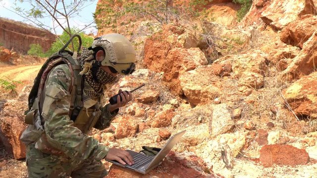 Soldiers of special forces on wars at the desert,Thailand people,Army soldier use laptop for see map with satellite,Using Radio For Communication During Military Operation	
