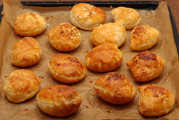 Freshly baked ruddy buns cool on the table