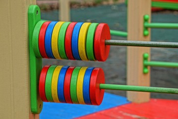 Naklejka premium large colored round wooden bills outside on the playground