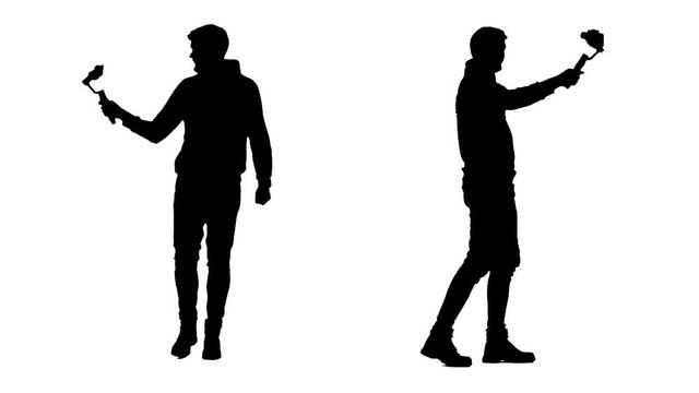 Two silhouettes shooting themselves while walking using steadicam and smartphone.