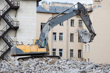 Building of the former hotel demolition for new construction, using a special hydraulic...