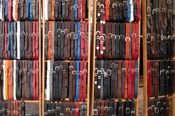 leather belts in artisan workshop for sale market background - obrazy, fototapety, plakaty
