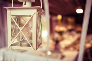  Wedding decorations. Rings on textiles, decorations with fresh flowers, candles, catering in purple tone. Stylish holiday atmosphere.Old lantern