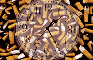 conceptual image of clock face and cigarette butts in ashtray