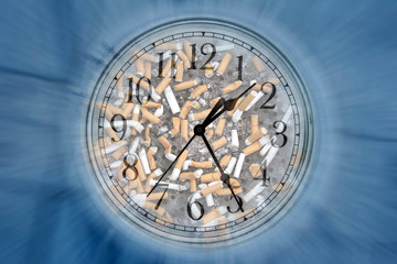 conceptual image of clock face and cigarette butts in ashtray