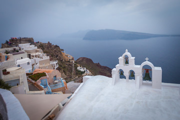 Tilt shift effect of orthodox church bells and caldera background